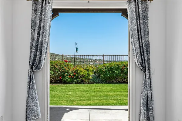 a view of a balcony with wooden chairs