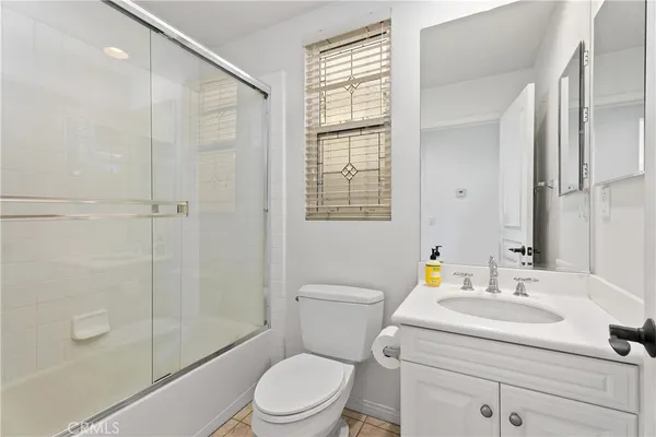 a spacious bathroom with a granite countertop sink a mirror and a