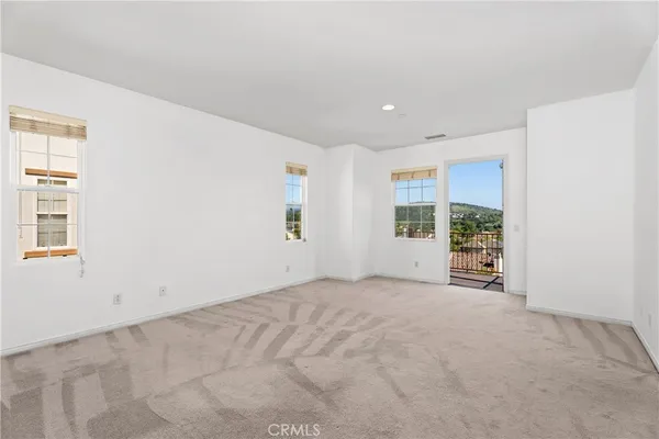 a bathroom with a toilet a sink and a large mirror