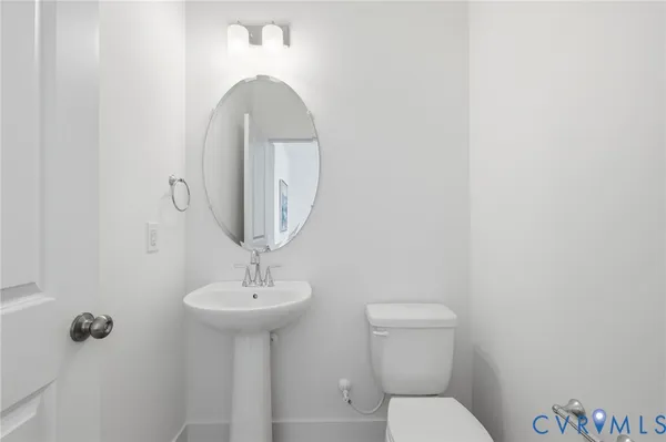 a bathroom with a toilet a sink and mirror