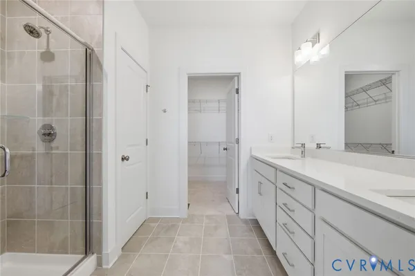 a spacious bathroom with a shower sink and mirror