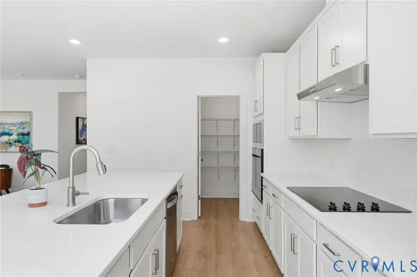 a kitchen with kitchen island a sink stove and refrigerator