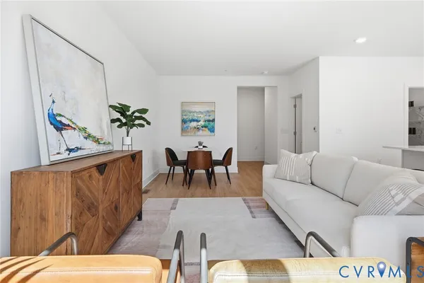 a living room with furniture and wooden floor