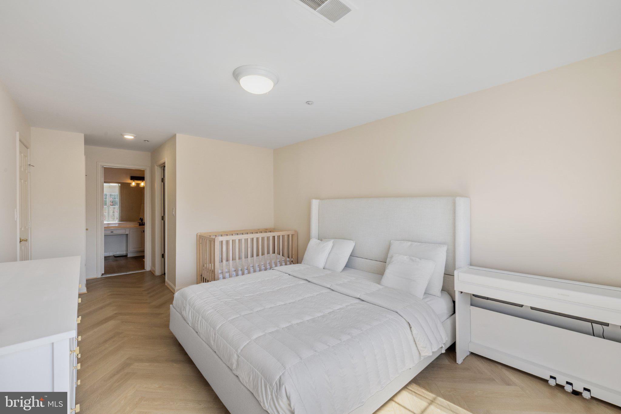 408 Ridgepoint Place, Unit 40838 Gaithersburg, MD 20878 - Photo 15 of 38 Serene bedroom with modern elegance.