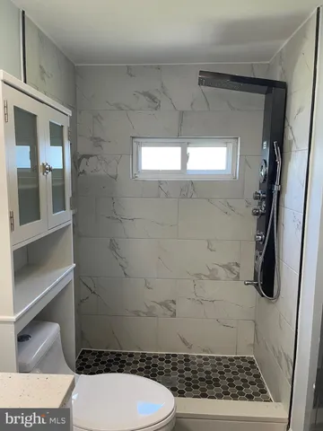 a bathroom with a toilet and a shower