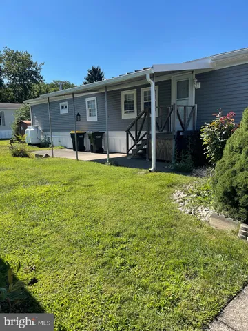 a front view of house with yard and seating space