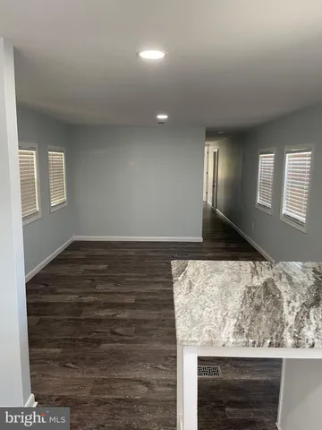 a view of lot of kitchen and hall with wooden floor