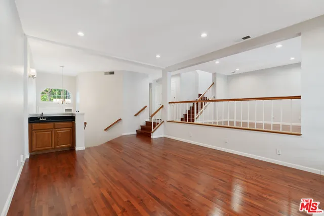 a bathroom with a granite countertop sink a toilet and shower