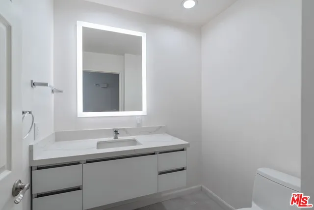 a bedroom with furniture and a flat screen tv