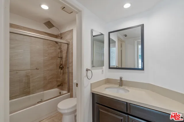 a view of staircase with wooden floor and a front door