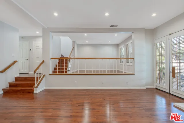 an empty room with wooden floor
