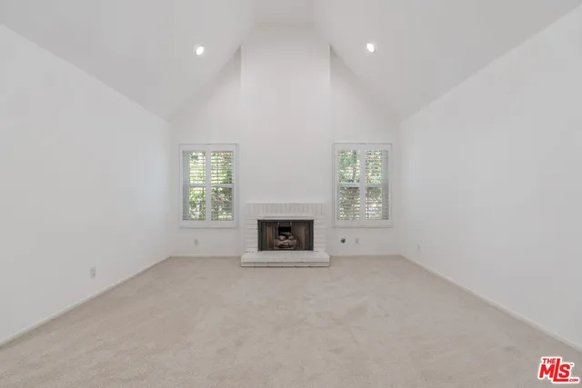 a kitchen with kitchen island a stove and a microwave