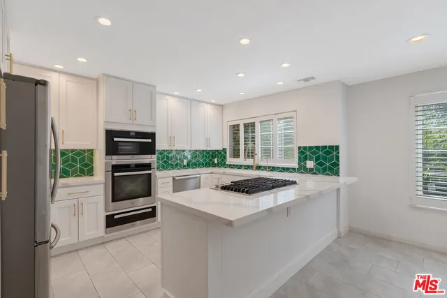 a view of a patio with chairs and potted plants