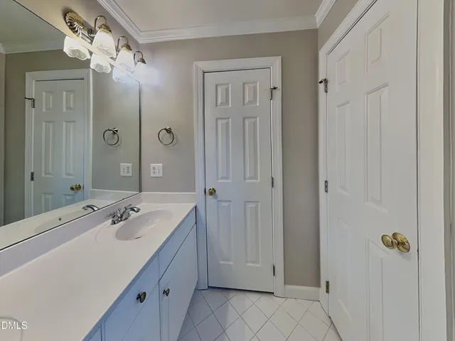 a spacious bathroom with a granite countertop sink a mirror a shower and a bathtub