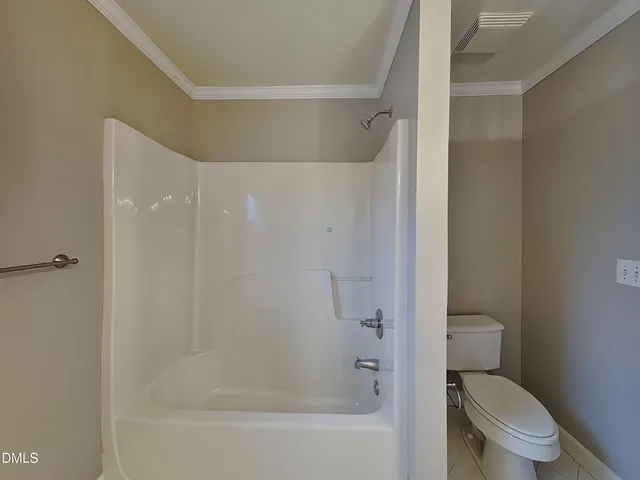 a bathroom with a shower and a toilet
