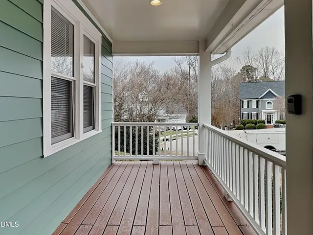 a view of a balcony with wooden floor