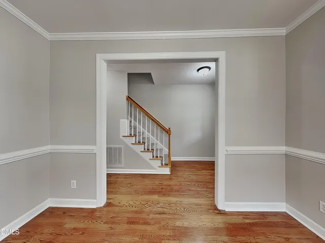 a view of entryway and hall with wooden floor