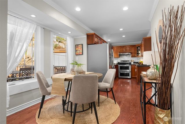 a view of a dining room with furniture window and wooden floor