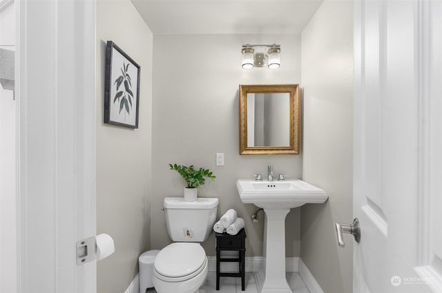 a bathroom with a sink mirror and toilet