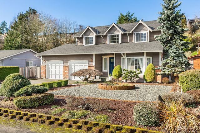 a front view of a house with garden