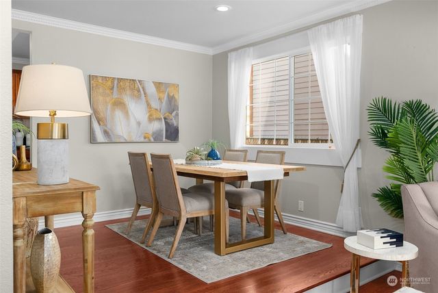 a view of a dining room with furniture and a potted plant