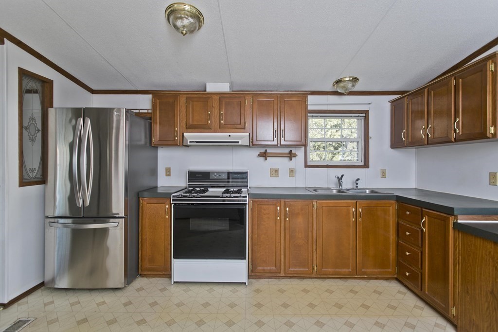 62 Holiday Circle Chicopee, MA 01020 - Photo 3 of 17 a kitchen with stainless steel appliances granite countertop a refrigerator sink and cabinets