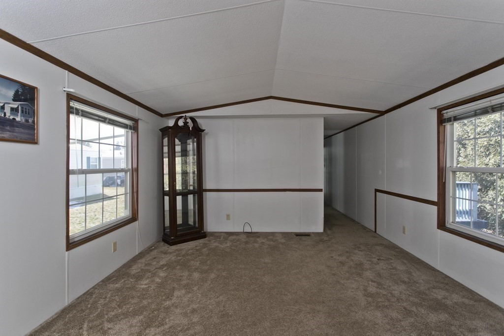 62 Holiday Circle Chicopee, MA 01020 - Photo 7 of 17 an empty room with windows and refrigerator