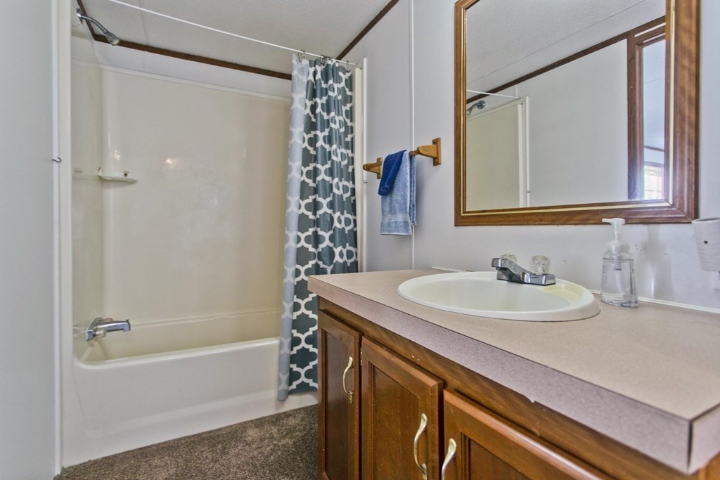 62 Holiday Circle Chicopee, MA 01020 - Photo 9 of 17 a bathroom with a sink and a mirror