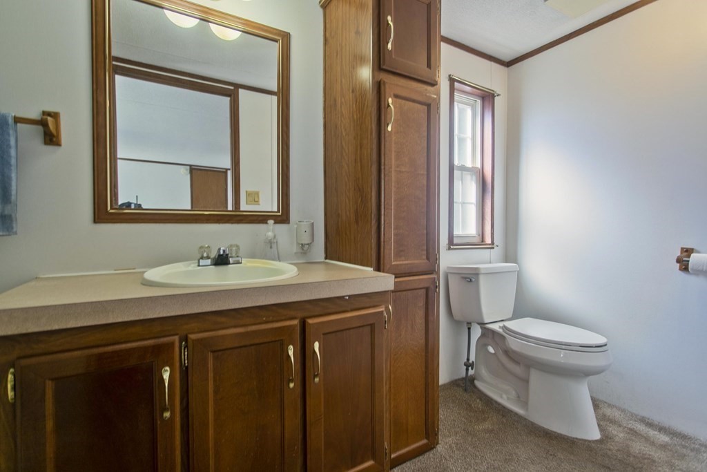 62 Holiday Circle Chicopee, MA 01020 - Photo 10 of 17 a bathroom with a granite countertop sink toilet and mirror