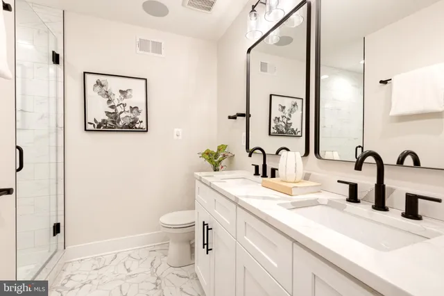 a bathroom with a sink a toilet and a mirror