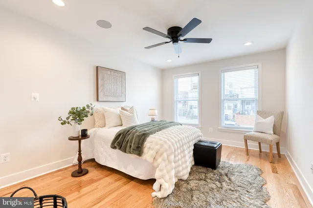 a spacious bedroom with a bed and a chandelier