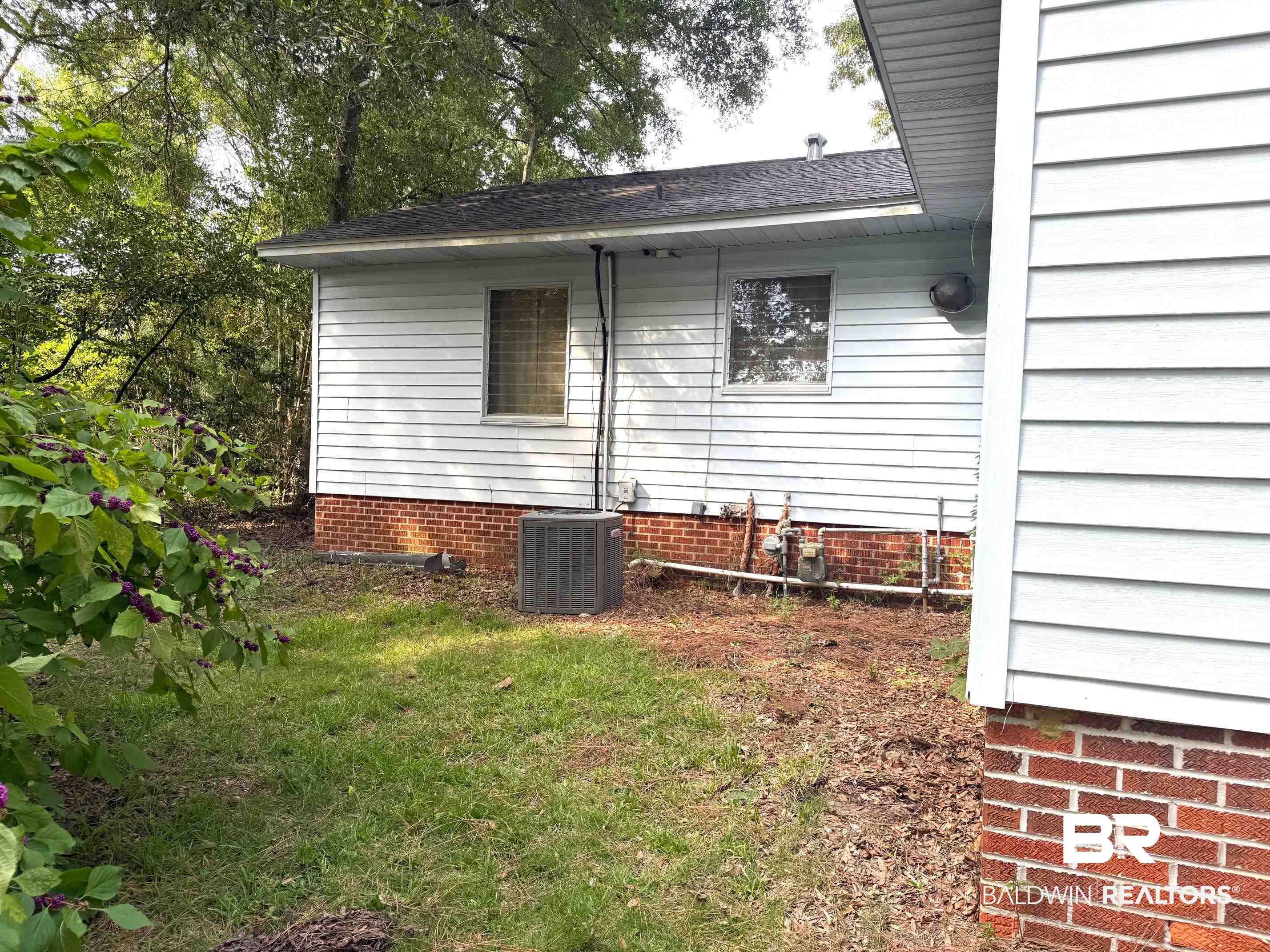156 Pier Avenue Fairhope, AL 36532 - Photo 35 of 41 View of side of property with roof with shingles and a lawn