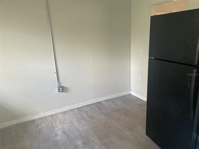 an empty room with wooden floor