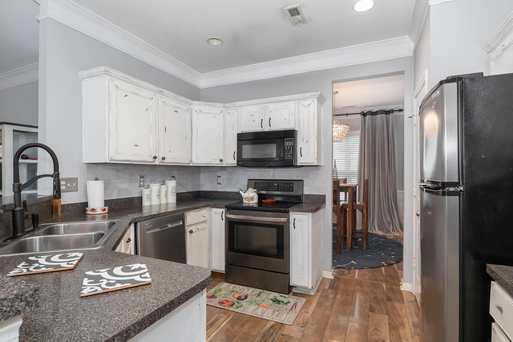 707 Harrier Road Charlotte, NC 28216 - Photo 13 of 29 a kitchen with stainless steel appliances granite countertop a sink stove refrigerator and cabinets