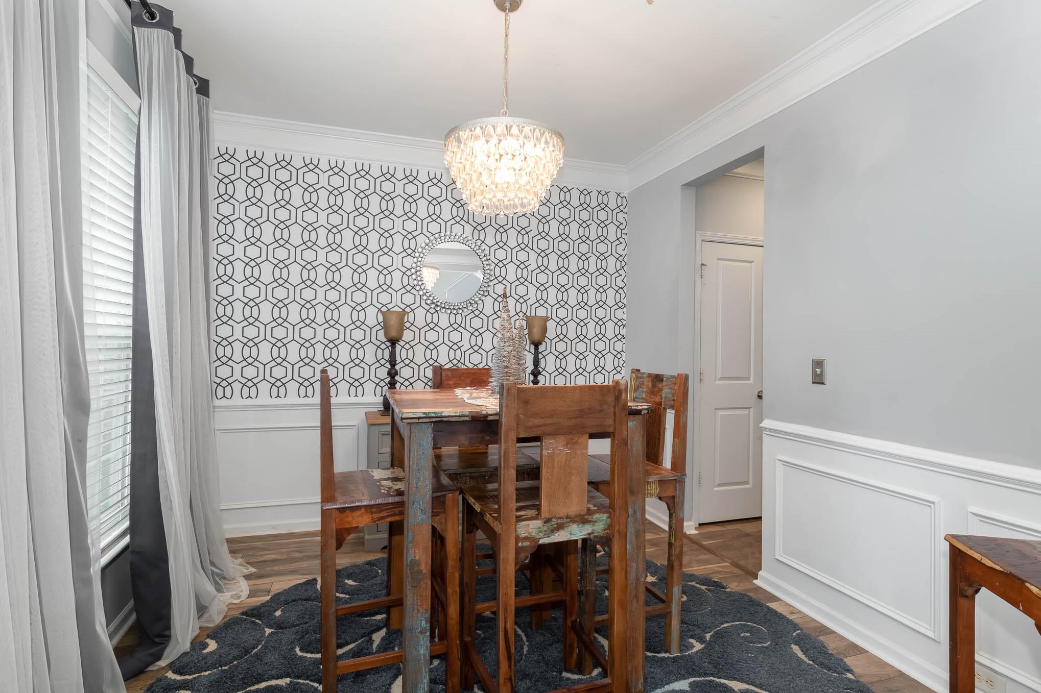707 Harrier Road Charlotte, NC 28216 - Photo 14 of 29 a view of a dining room with furniture and wooden floor