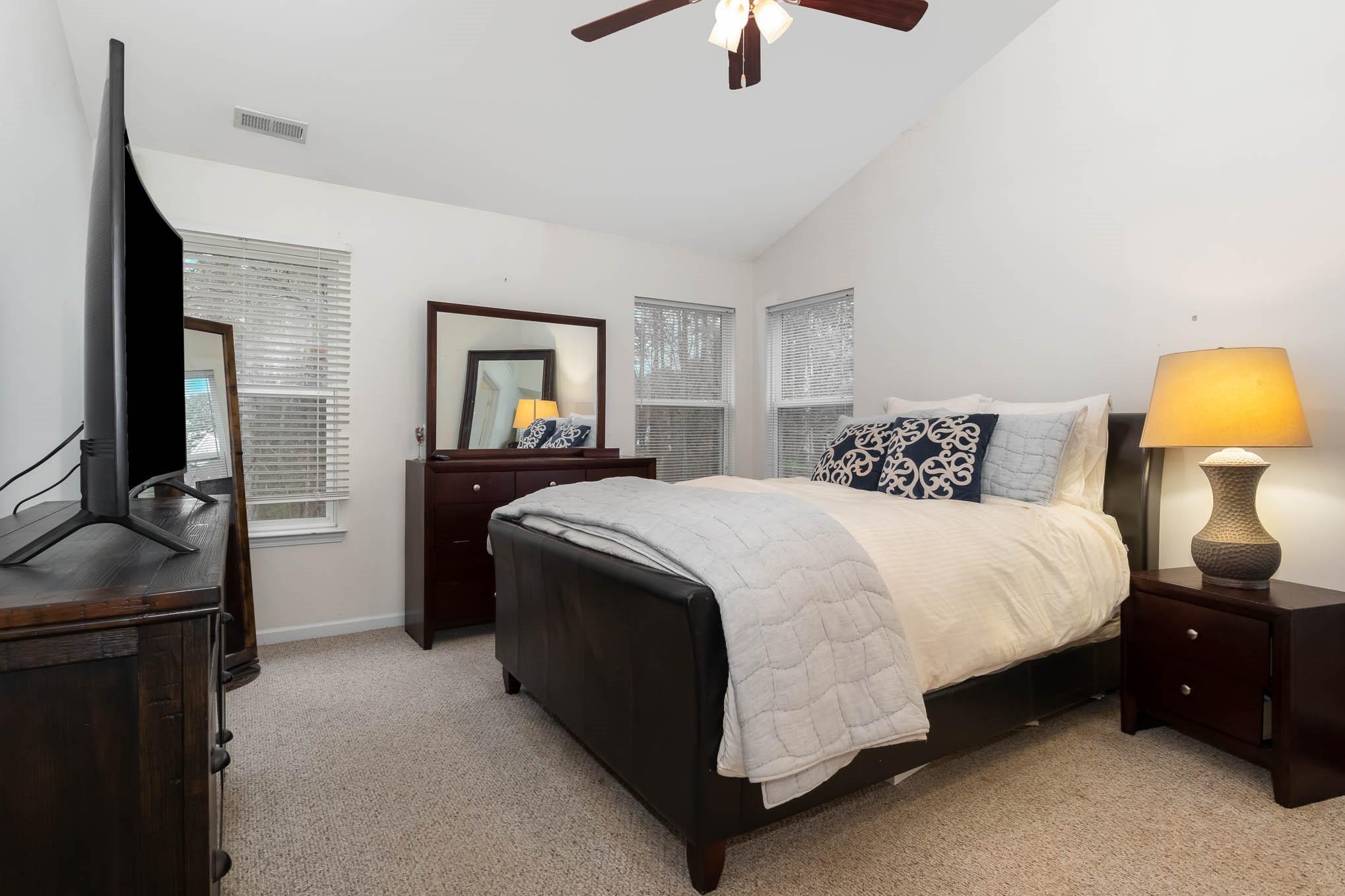 707 Harrier Road Charlotte, NC 28216 - Photo 15 of 29 a bedroom with a bed and a chandelier