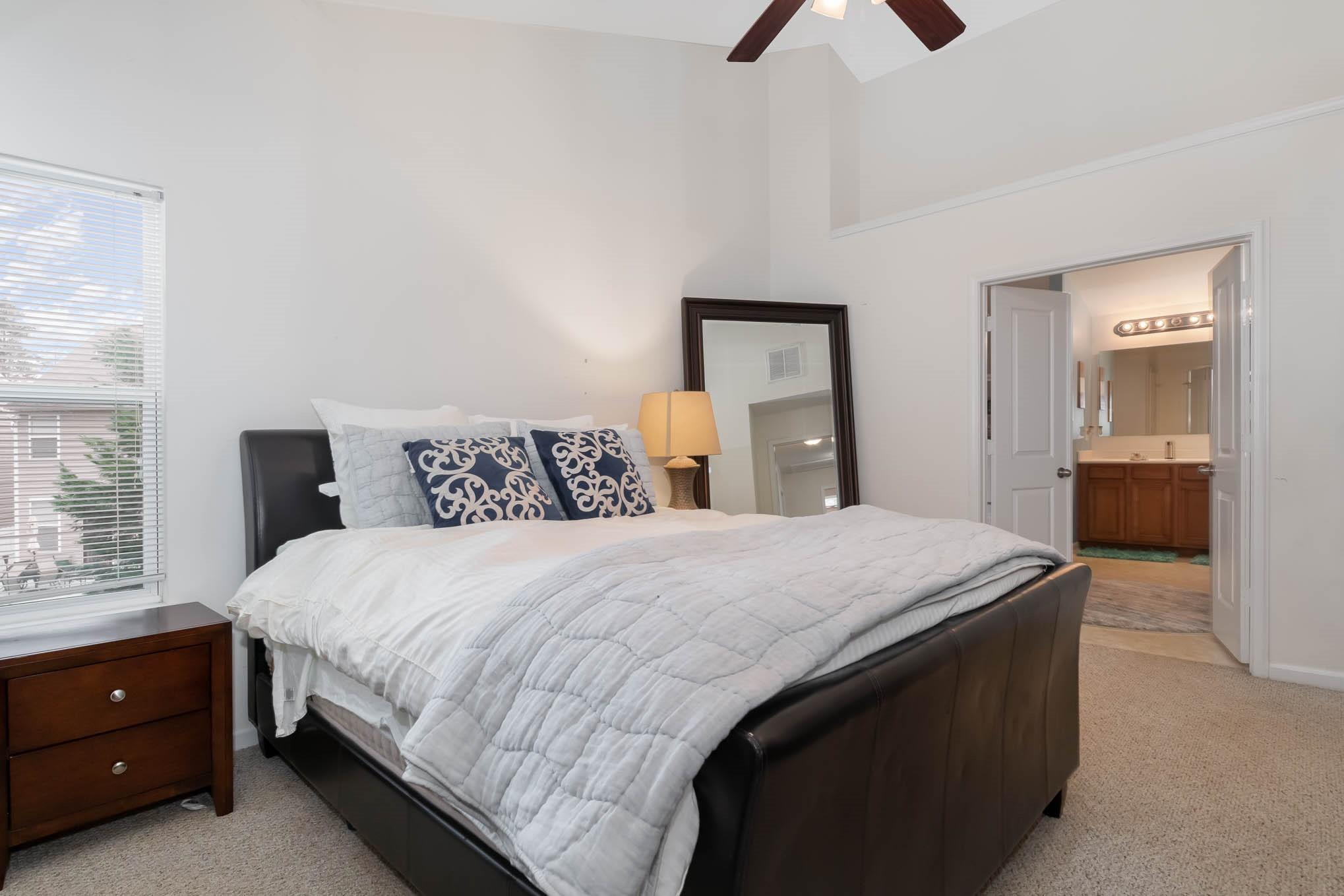 707 Harrier Road Charlotte, NC 28216 - Photo 16 of 29 a bedroom with a bed and a chandelier