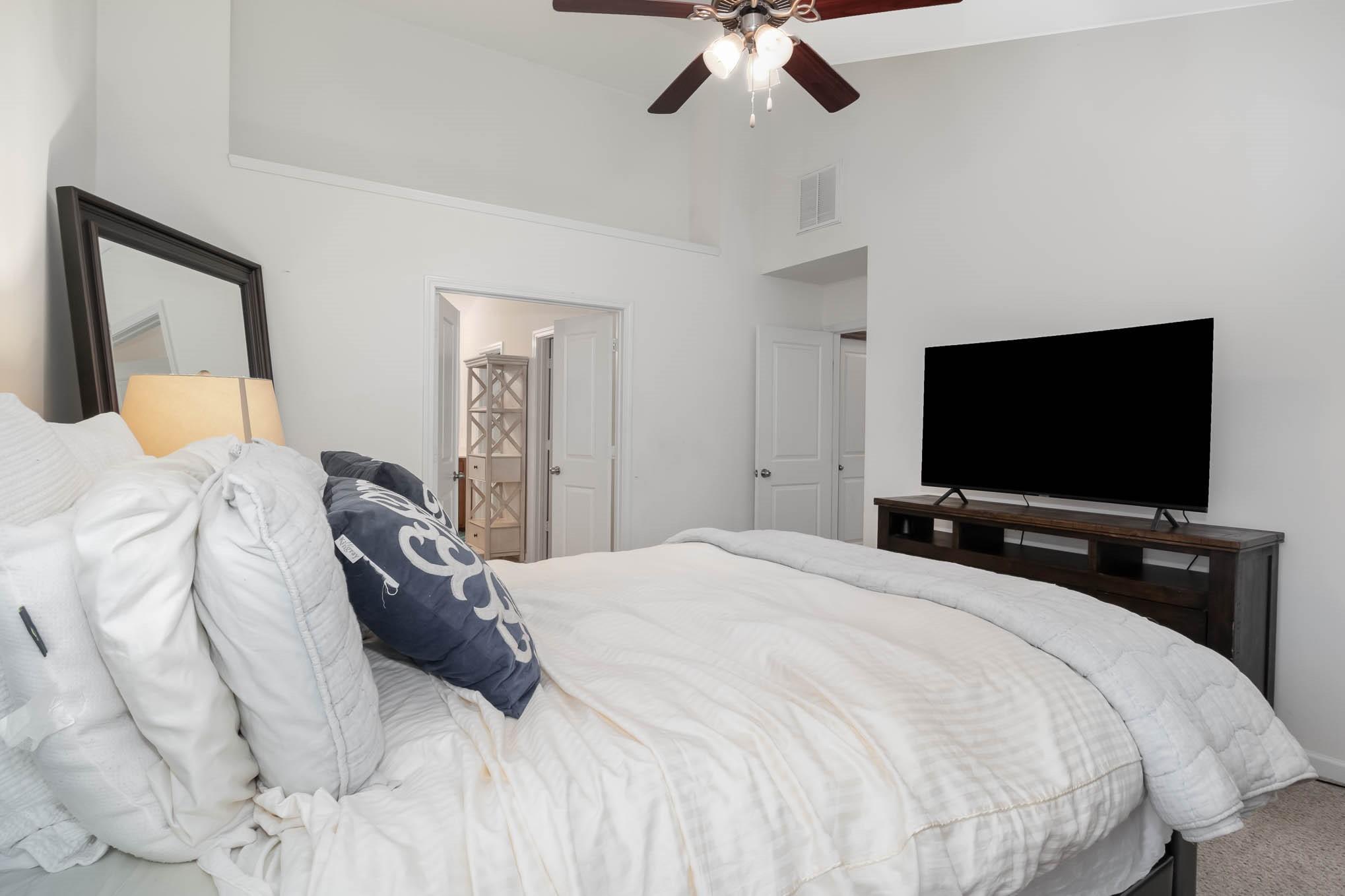 707 Harrier Road Charlotte, NC 28216 - Photo 17 of 29 a bedroom with a bed and a flat screen tv