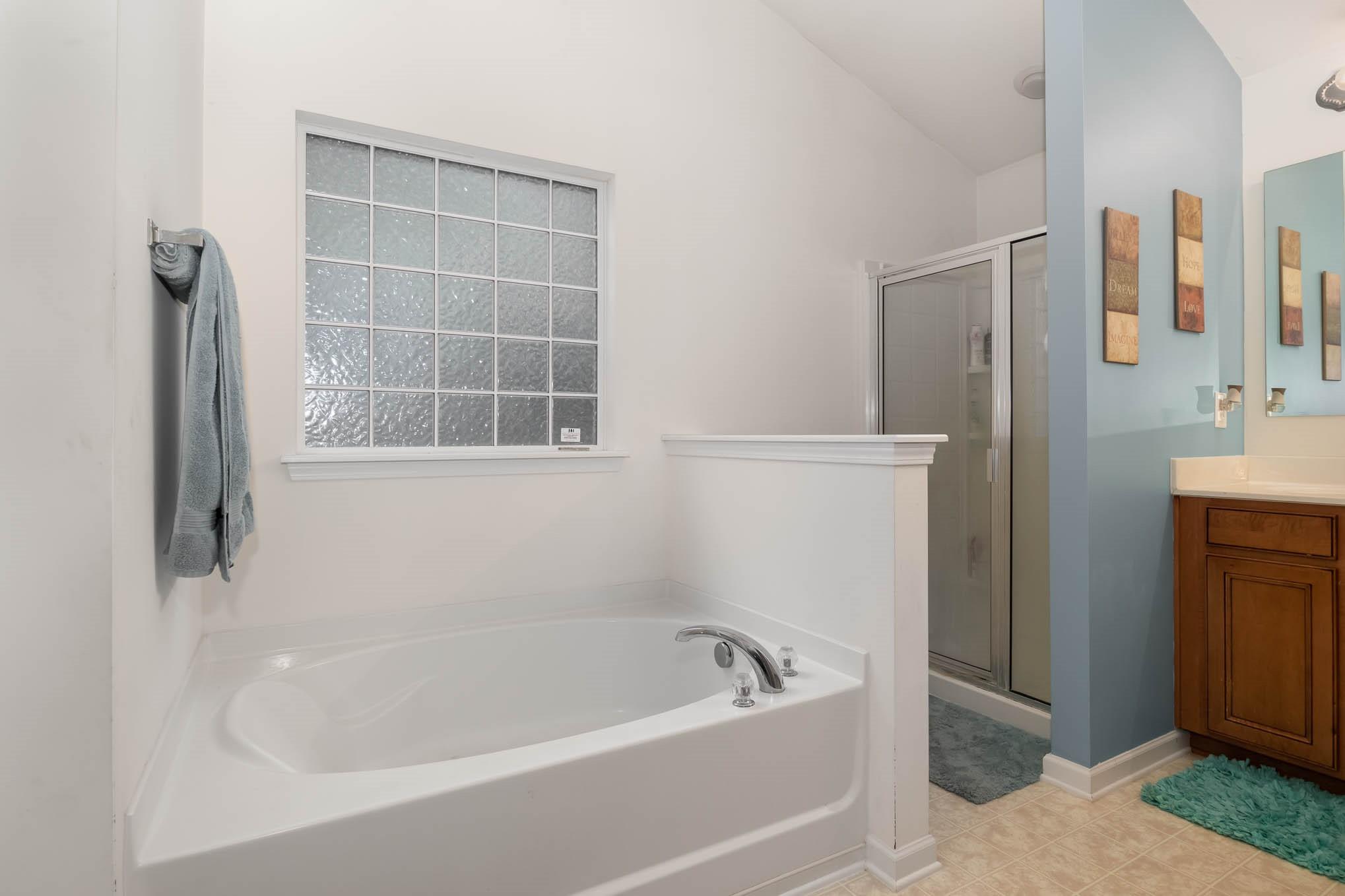 707 Harrier Road Charlotte, NC 28216 - Photo 19 of 29 a bath tub sitting next to a bathroom sink
