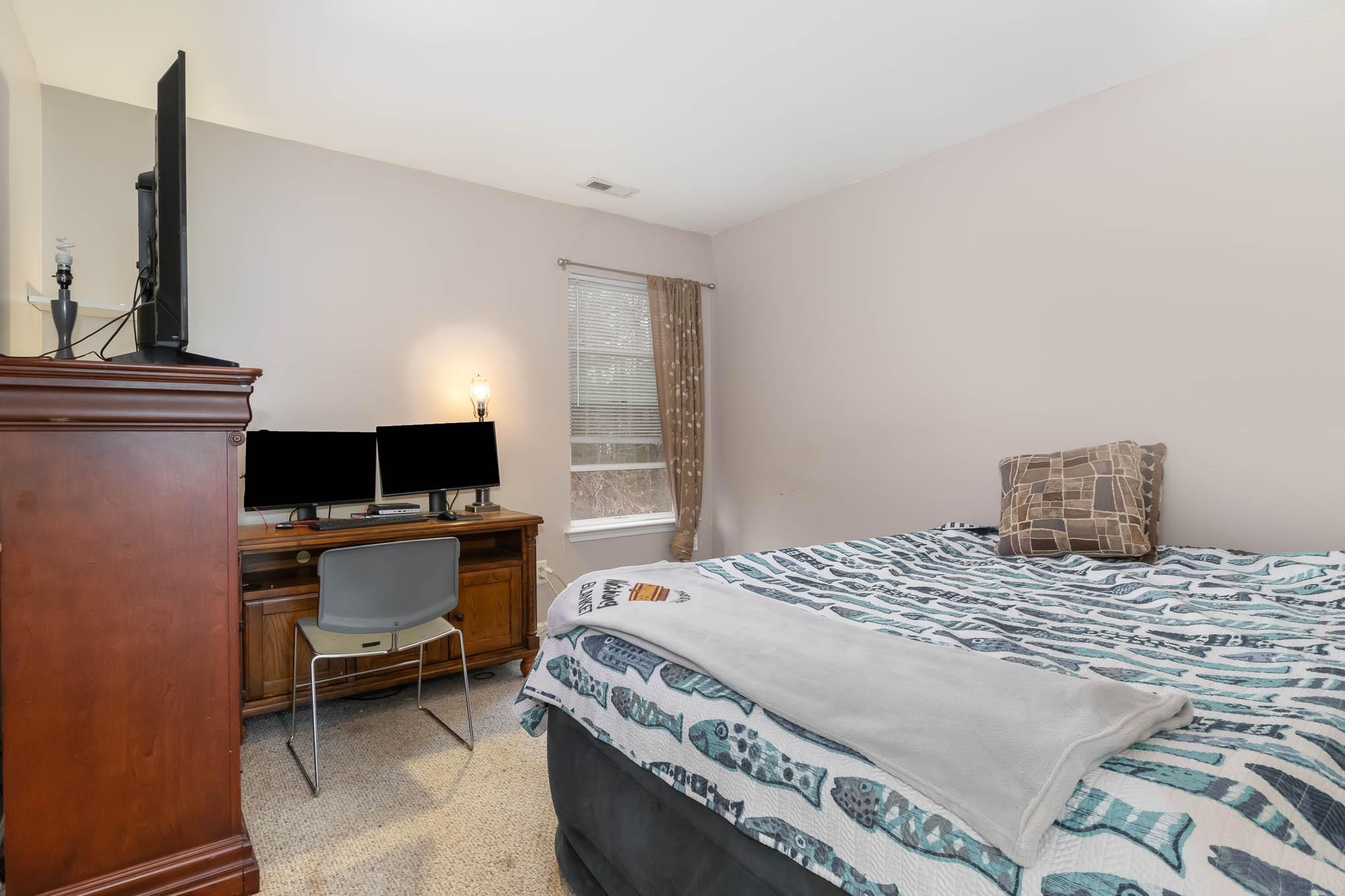 707 Harrier Road Charlotte, NC 28216 - Photo 20 of 29 a bedroom with a bed and a computer on a table