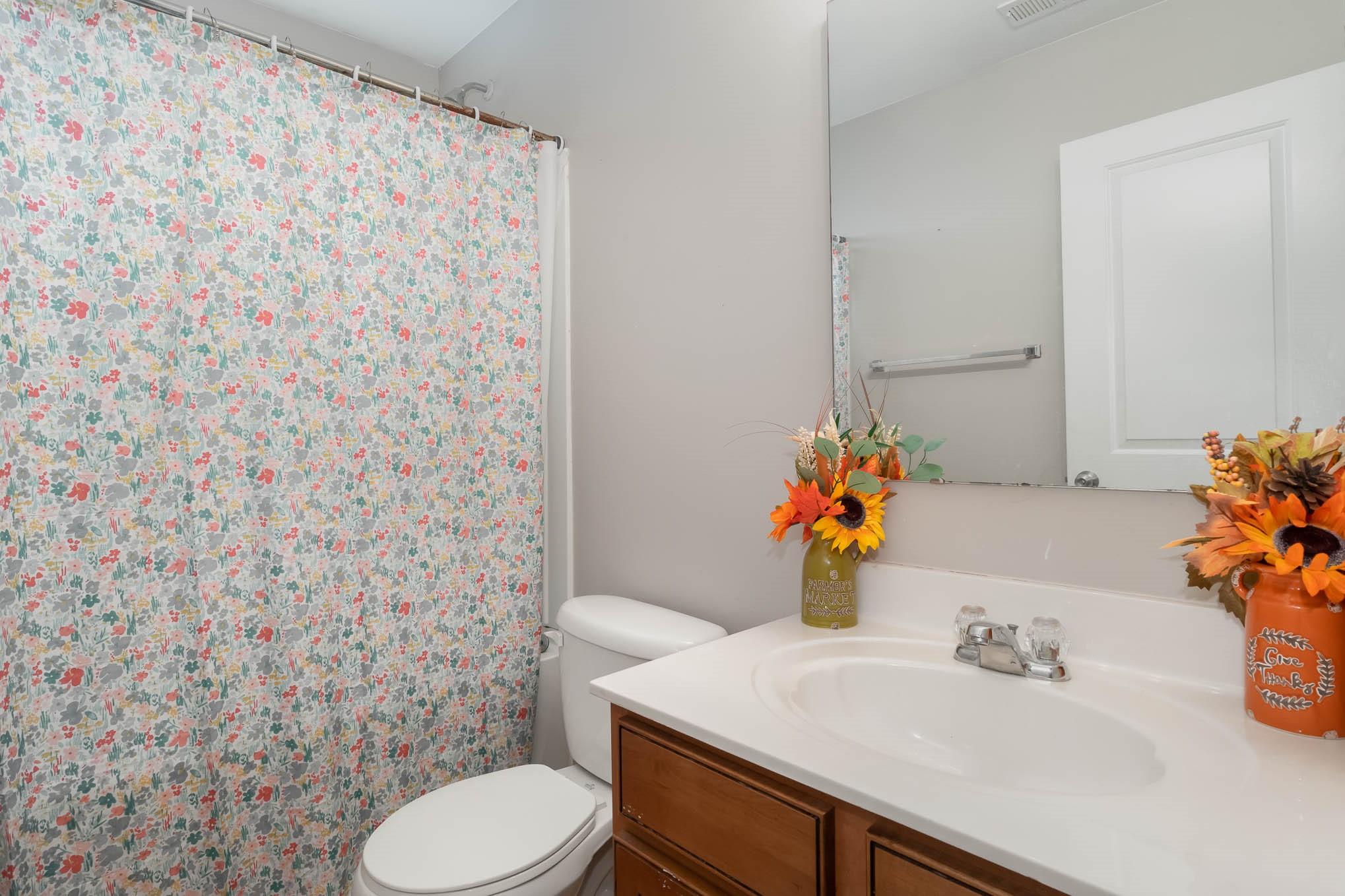 707 Harrier Road Charlotte, NC 28216 - Photo 22 of 29 a bathroom with a sink toilet and mirror