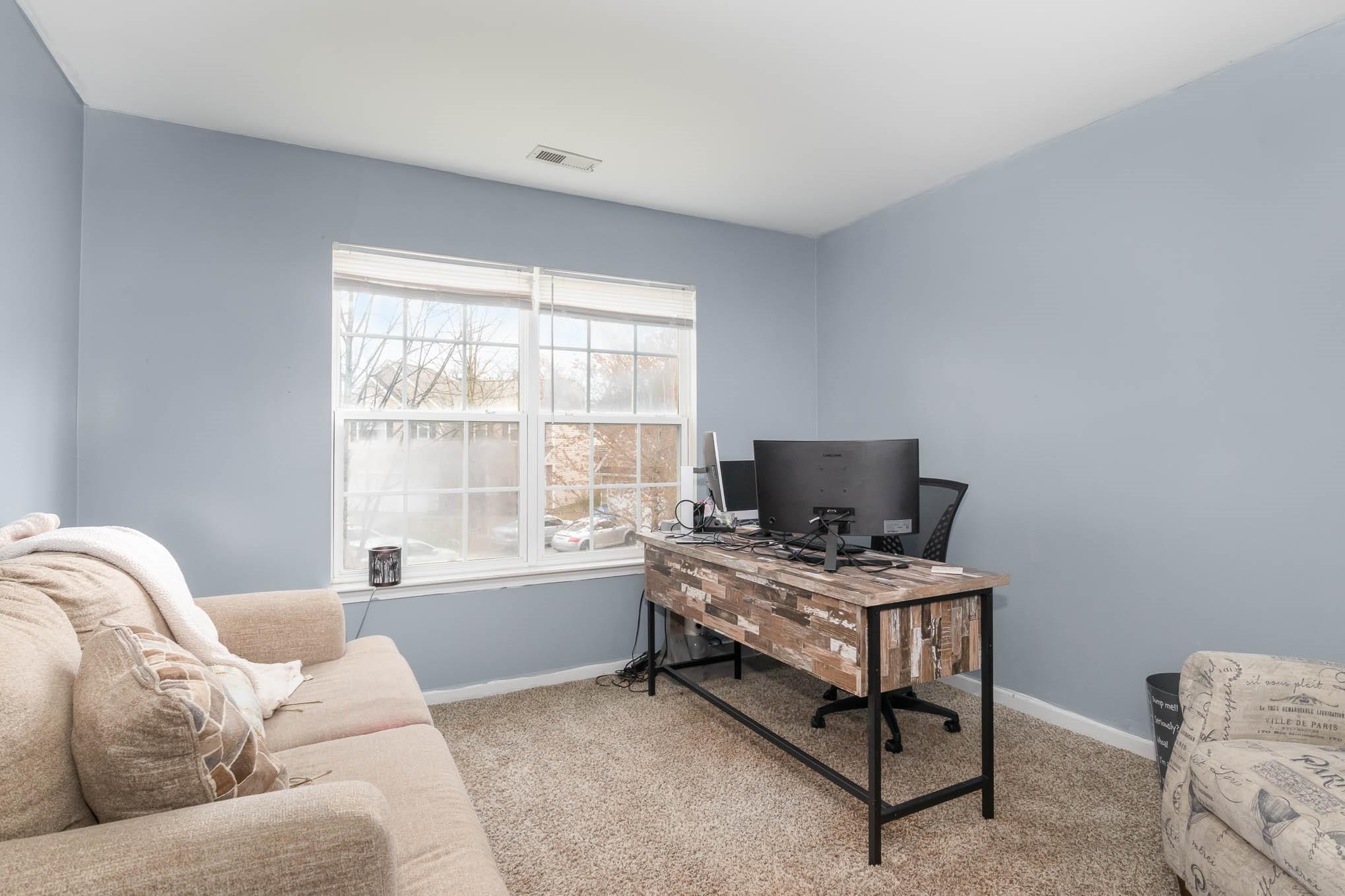 707 Harrier Road Charlotte, NC 28216 - Photo 23 of 29 a bedroom with furniture and a window