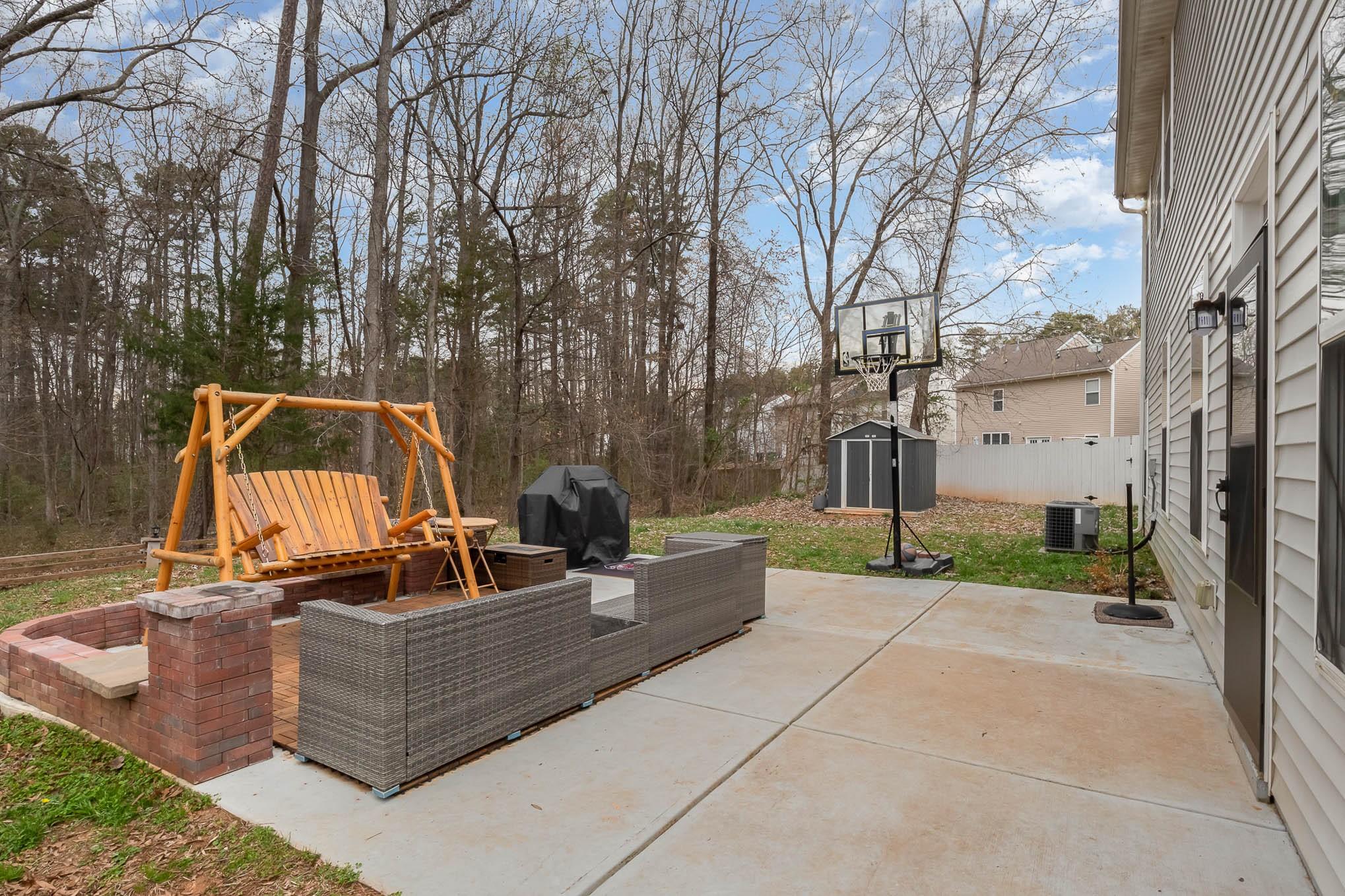 707 Harrier Road Charlotte, NC 28216 - Photo 25 of 29 a view of a chair and fire pit in the backyard
