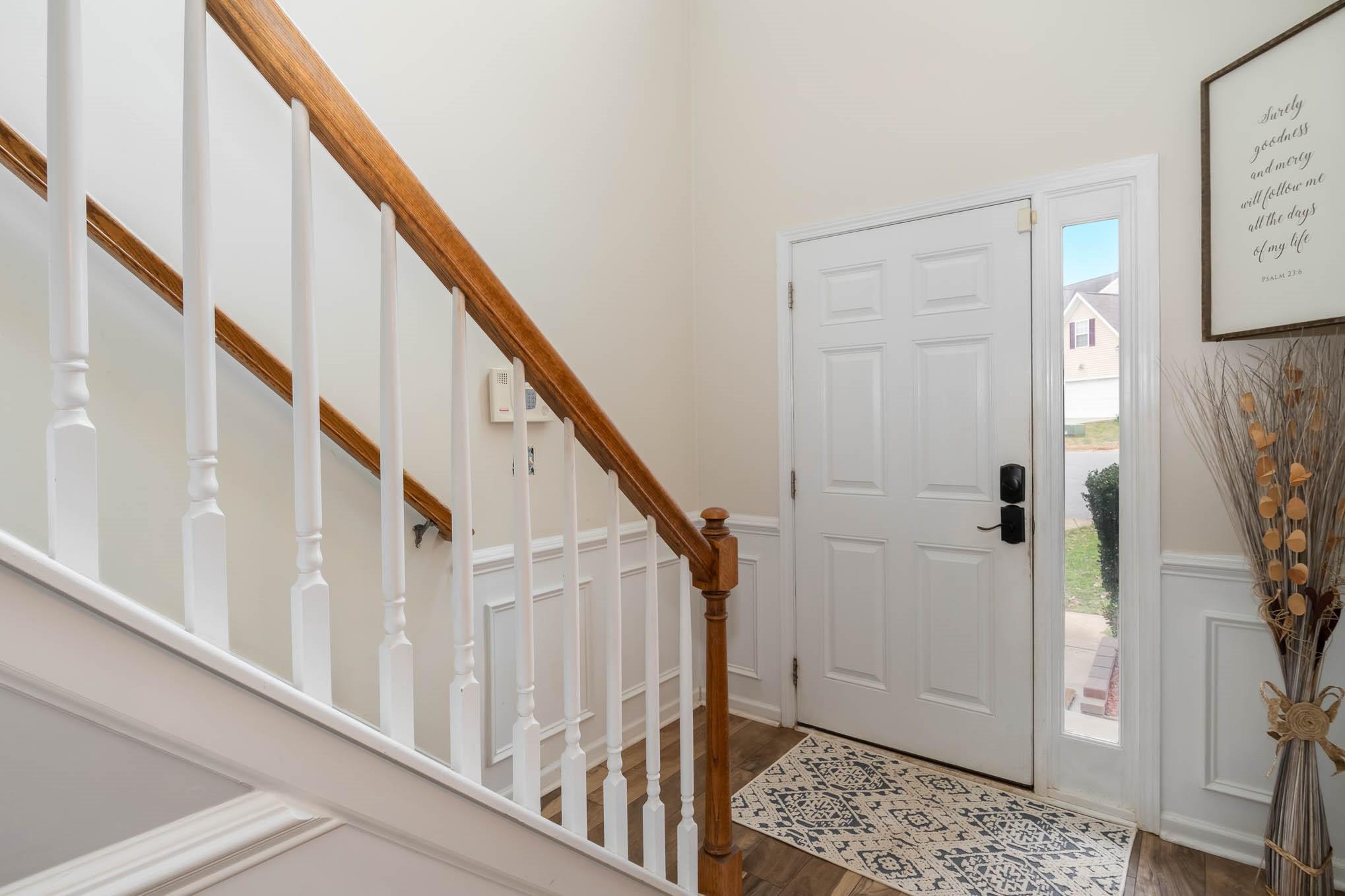 707 Harrier Road Charlotte, NC 28216 - Photo 4 of 29 a view of entryway with wooden floor and stairs