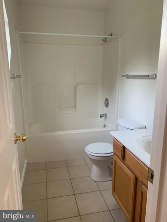 a bathroom with a toilet a sink and shower