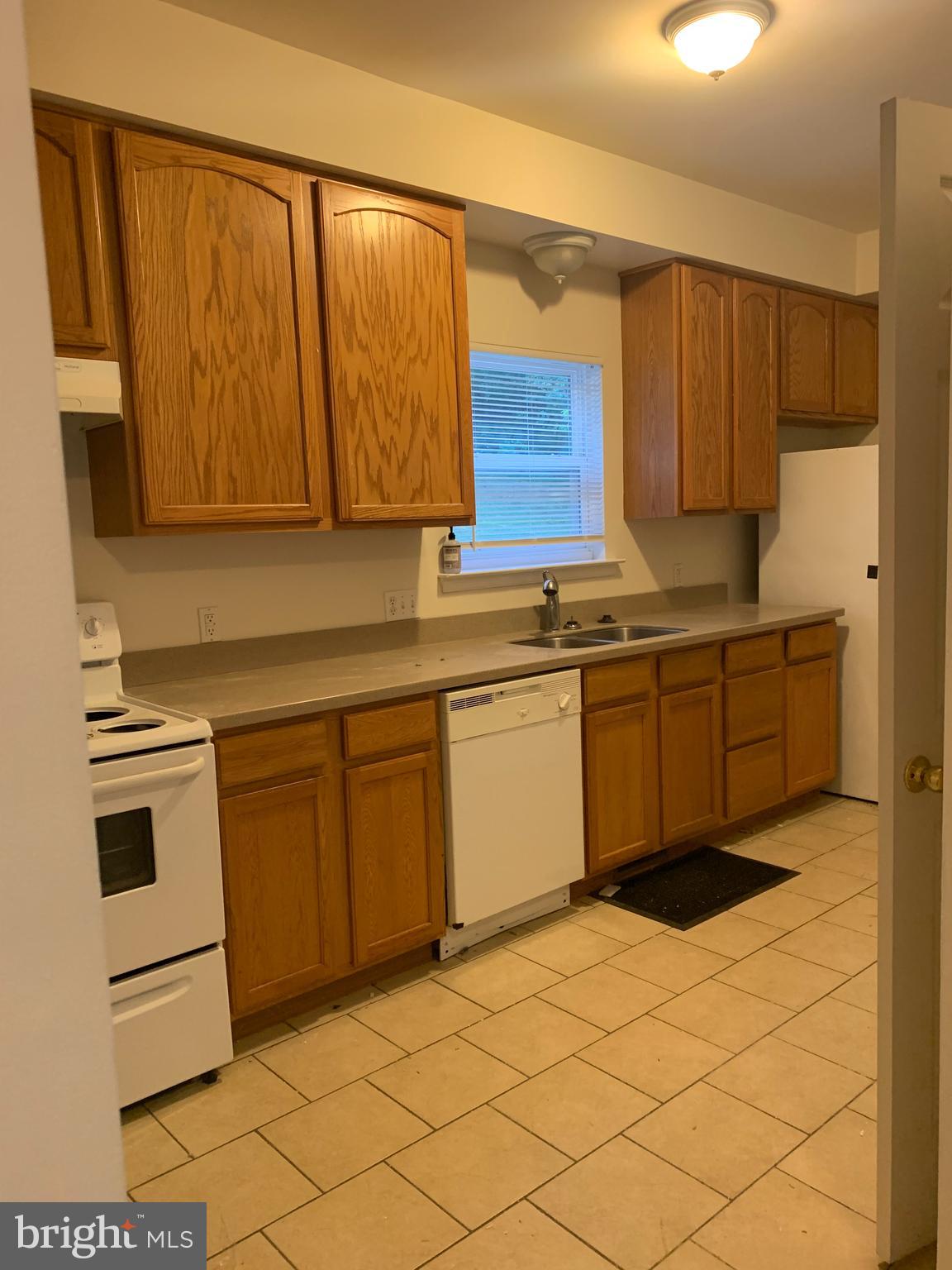5061 Bayside Road Chesapeake Beach, MD 20732 - Photo 8 of 15 a kitchen with a sink cabinets and window