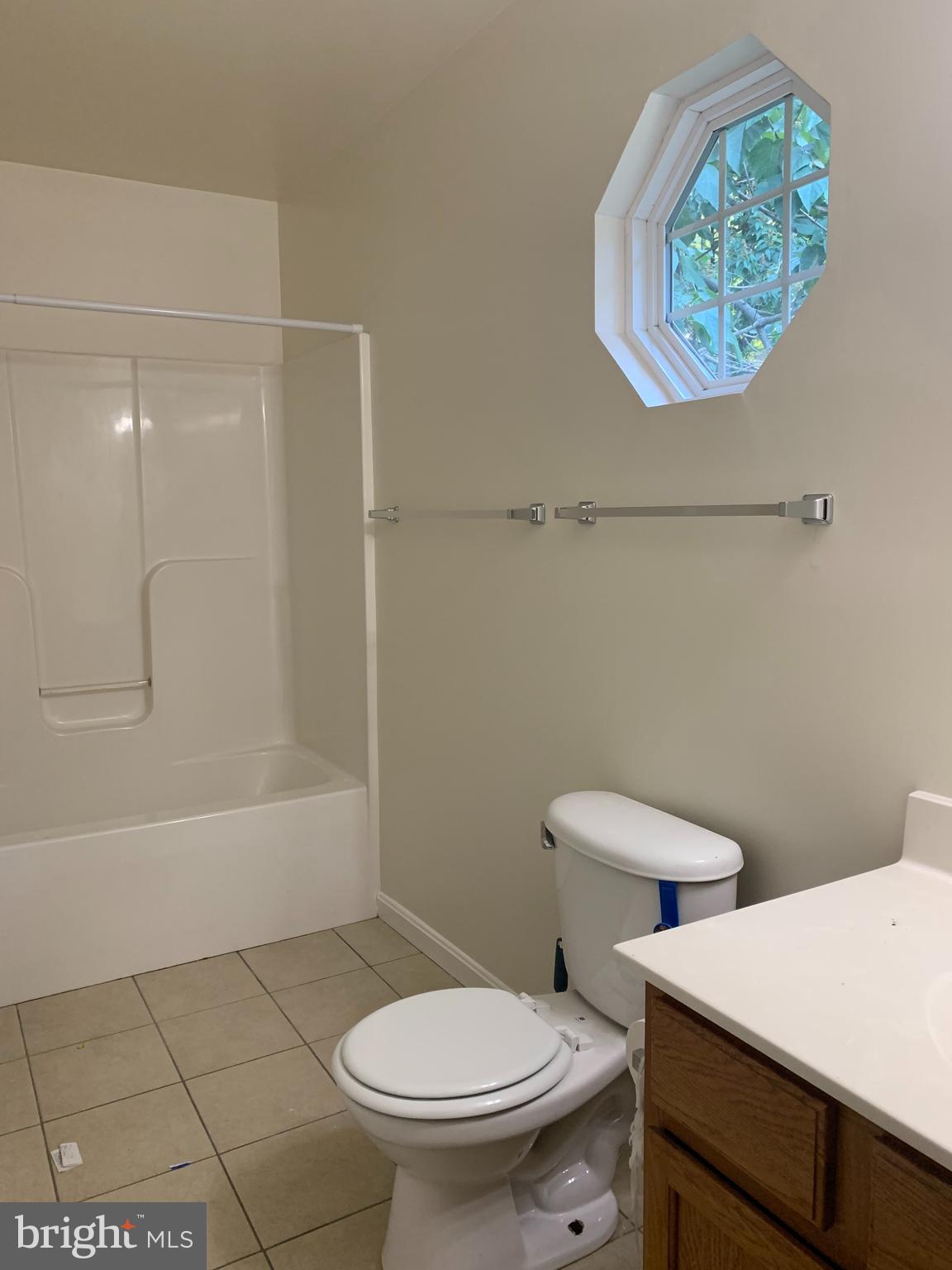 5061 Bayside Road Chesapeake Beach, MD 20732 - Photo 10 of 15 a white toilet sitting next to a bath tub