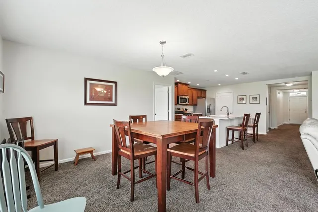 a view of kitchen with sink dining table and chairs