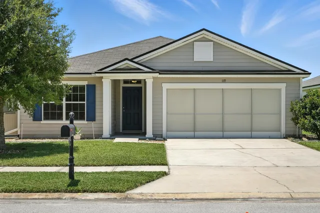 an aerial view of a house with a yard basket ball court and outdoor seating