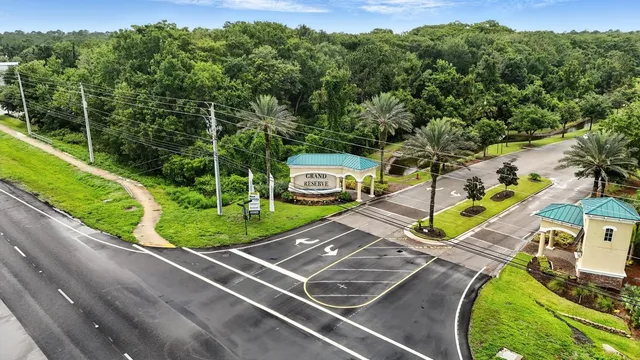 a front view of a house with a yard and trees